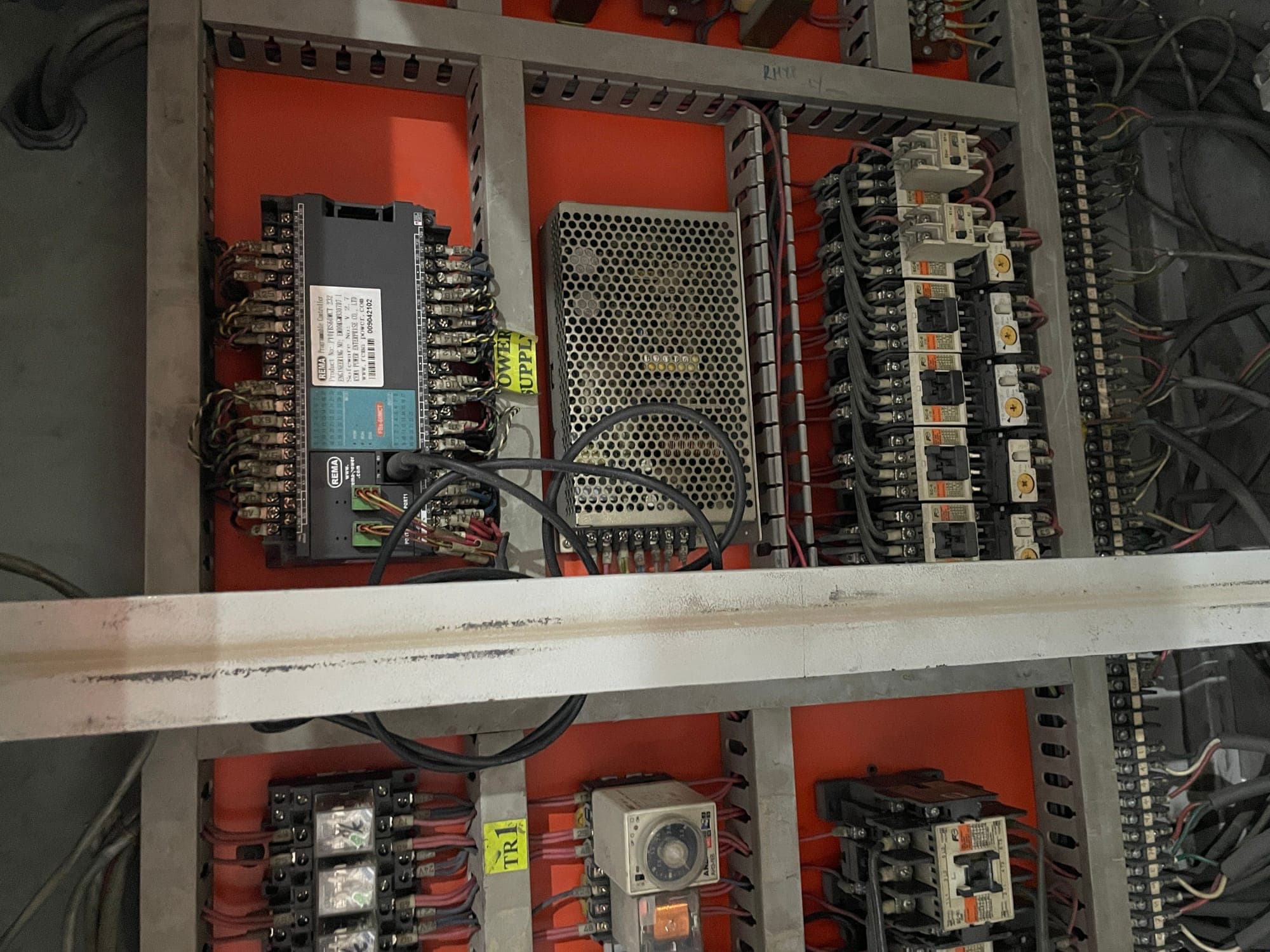 Working live inside the cabinet — control circuit verification before re-energizing.